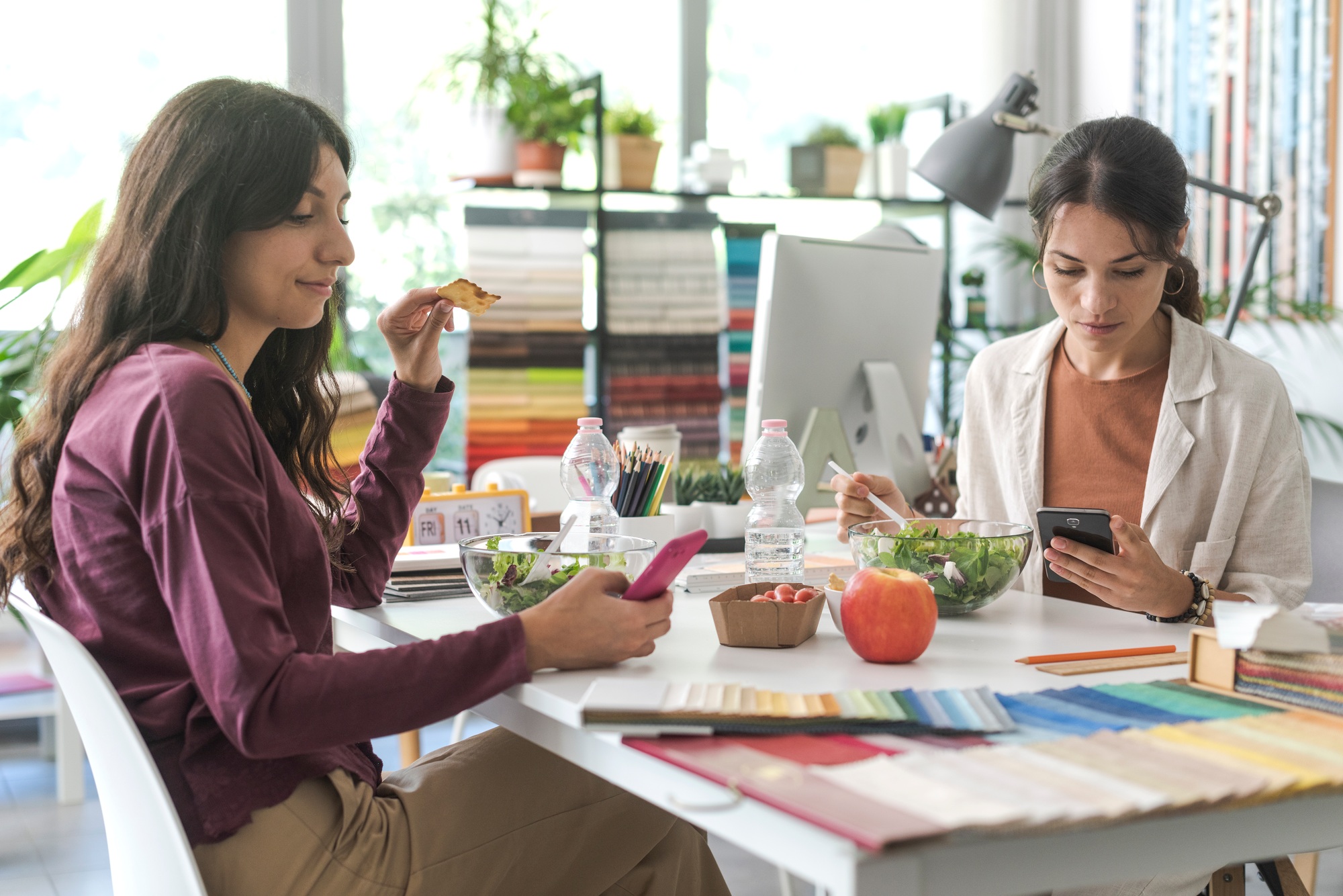 Women using smartphones during the lunch break